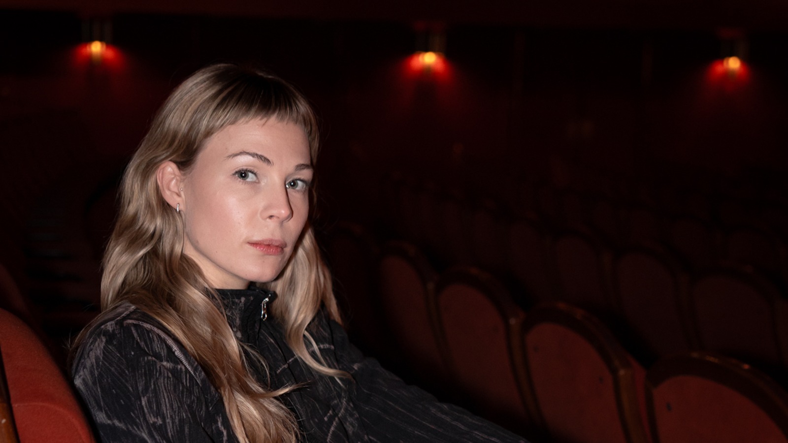 Beatrice Karlsson, programme director of Stockholm International Film Festival, seated in a red cinema chair